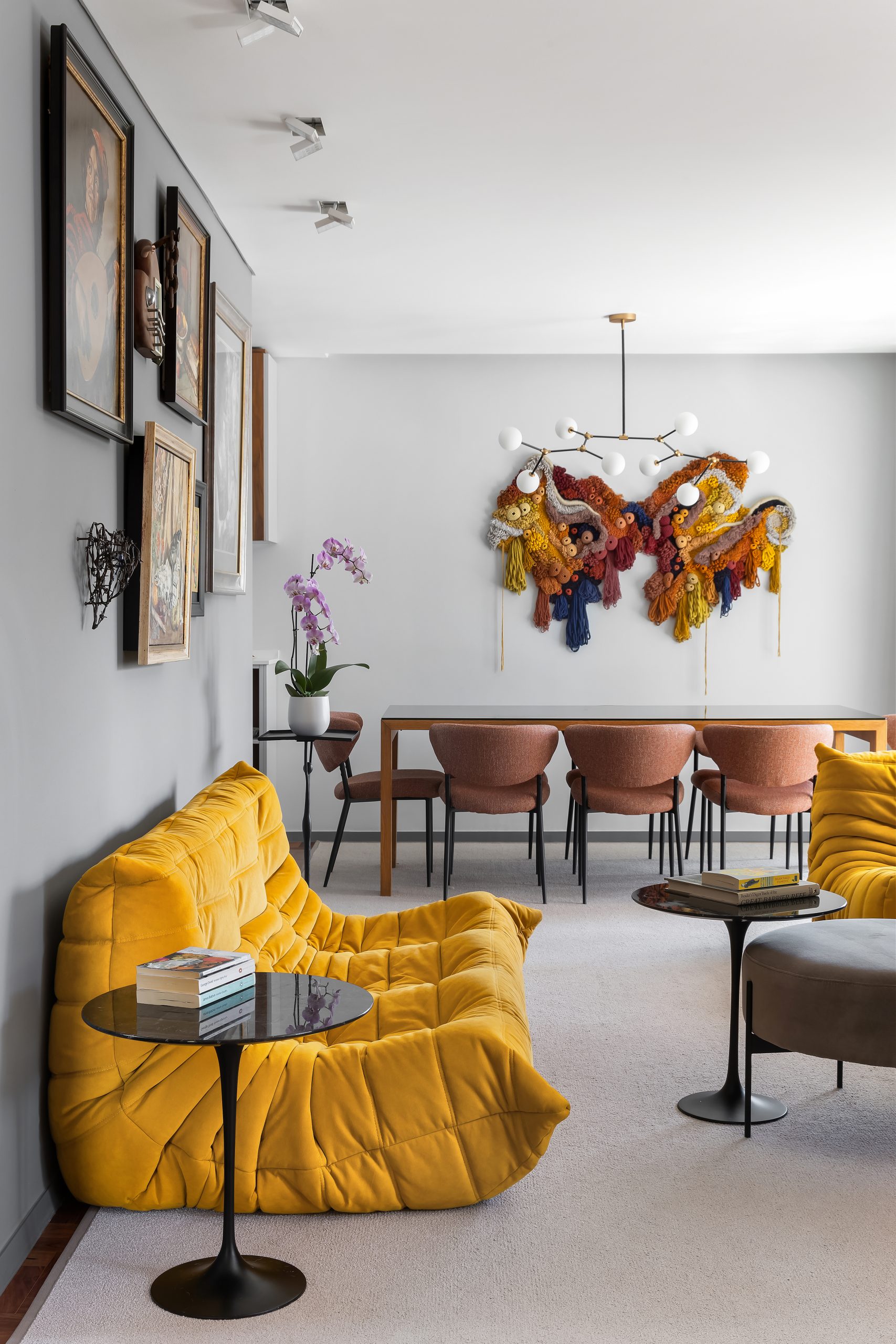 Yellow sofa and dining room of the Cascais Retreat Project.